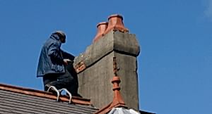 Repairing chimney stack on a roof